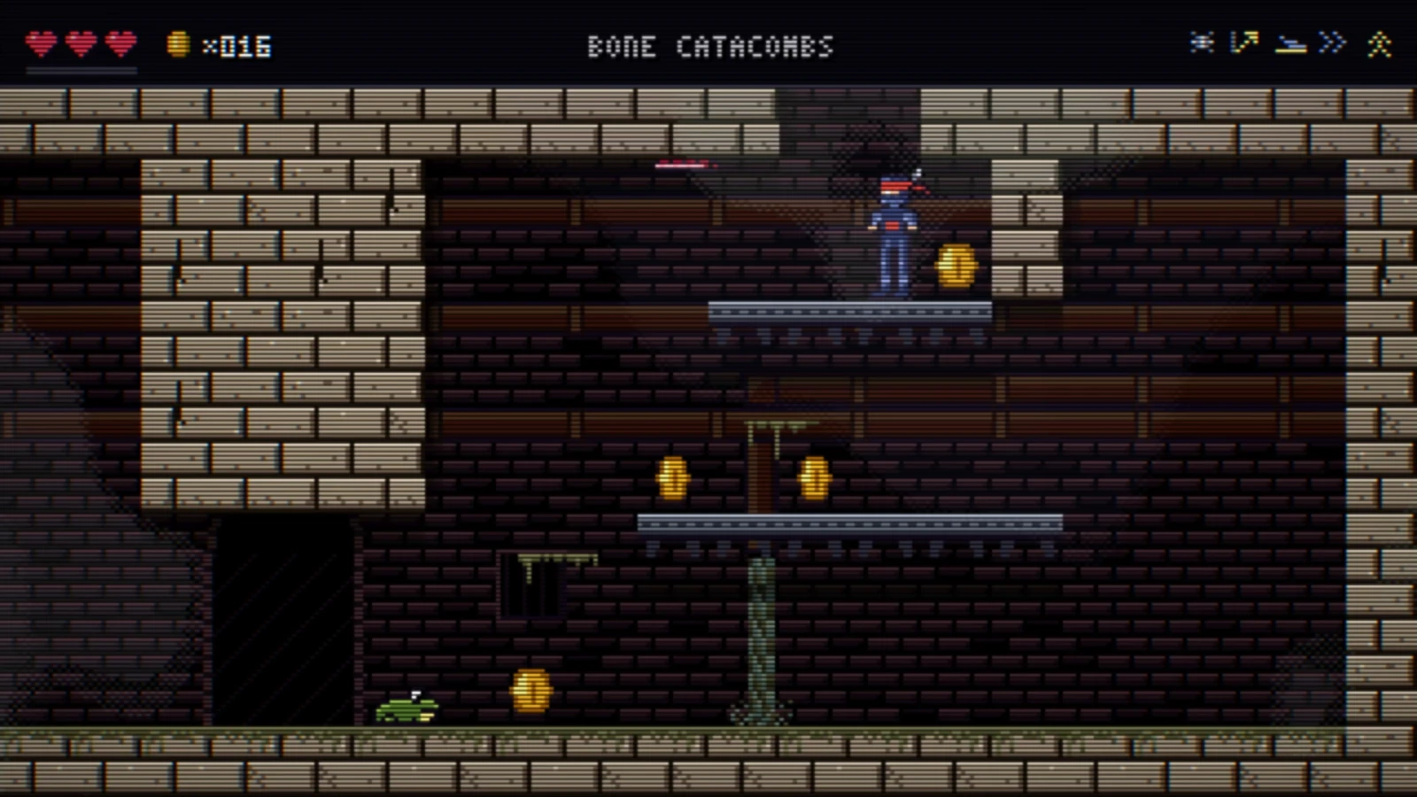 The ninja on a platform in the Bone Catacombs, a room of pale stone over dark brick, with coins and a small green frog on the floor.